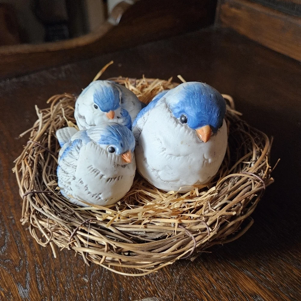 Fat blue bird mama and babies on nest figurine.